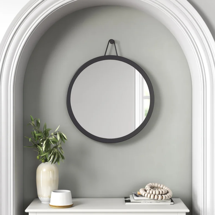 a round metal wall mirror
