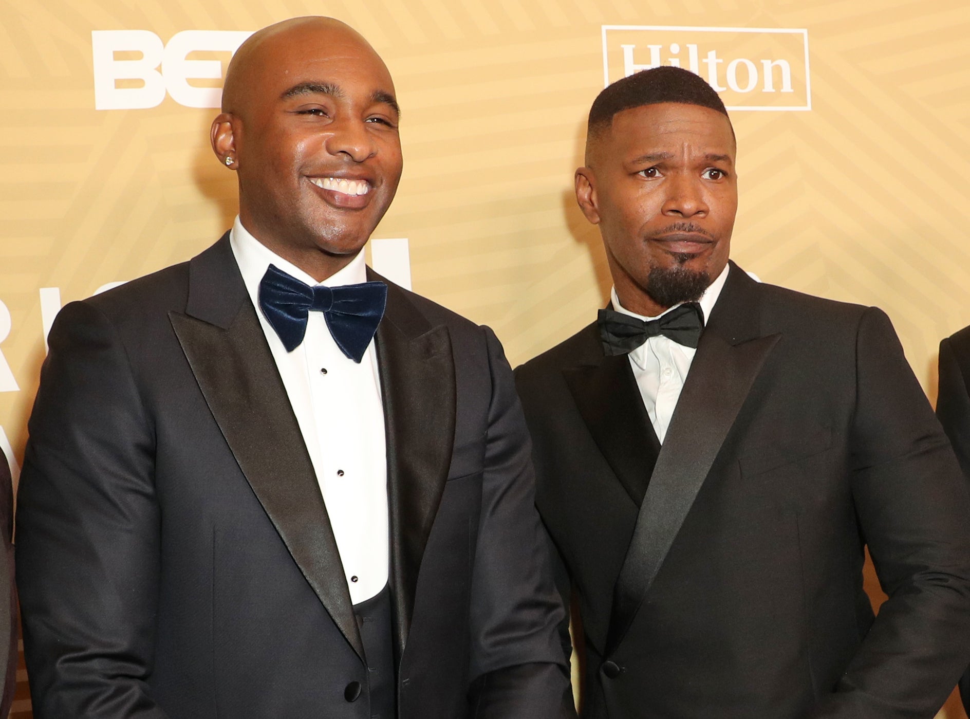 A close-up of Jamie and Datari in bow ties at a media event