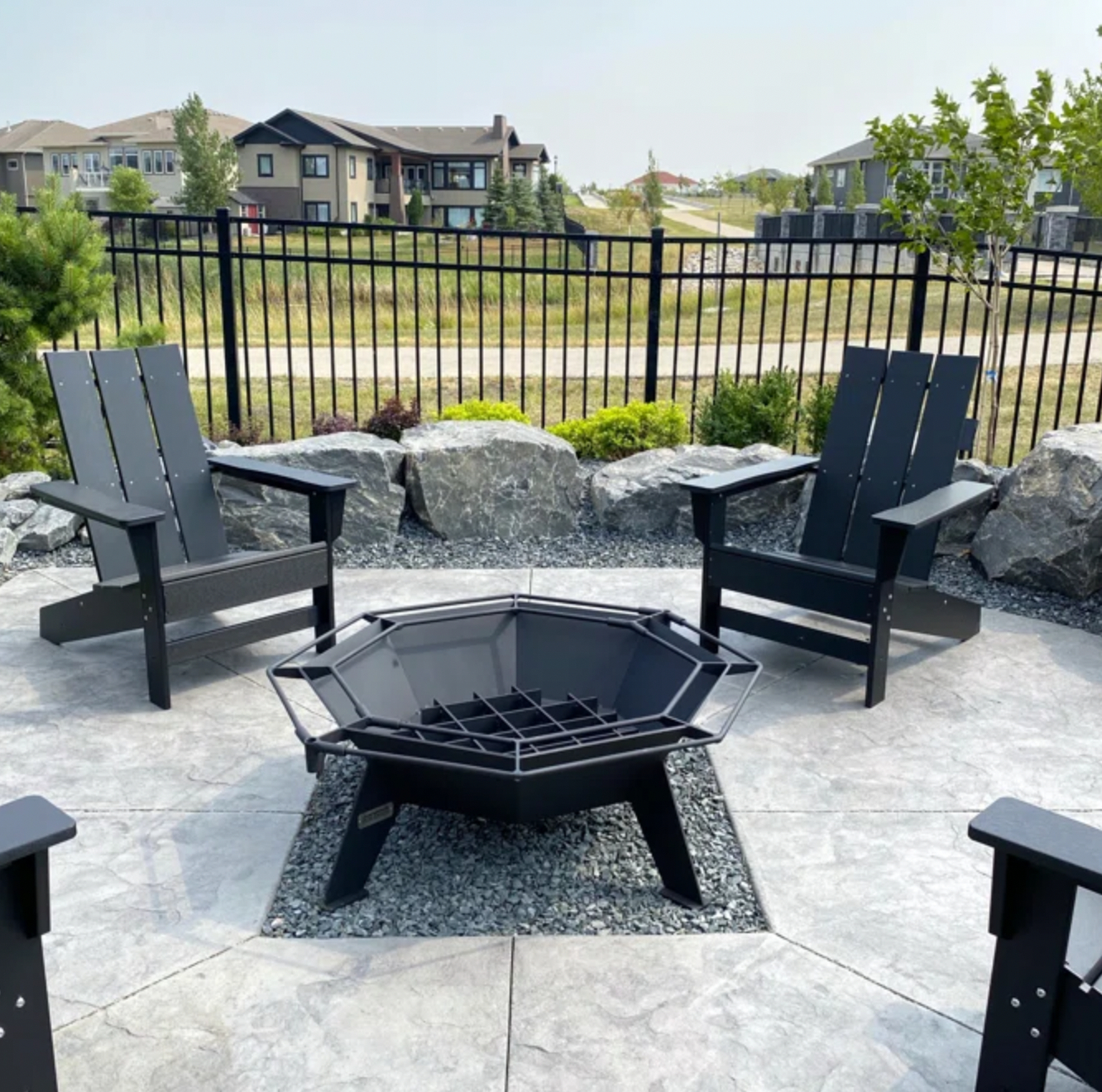 reviewer&#x27;s outdoor patio with four chairs around firepit