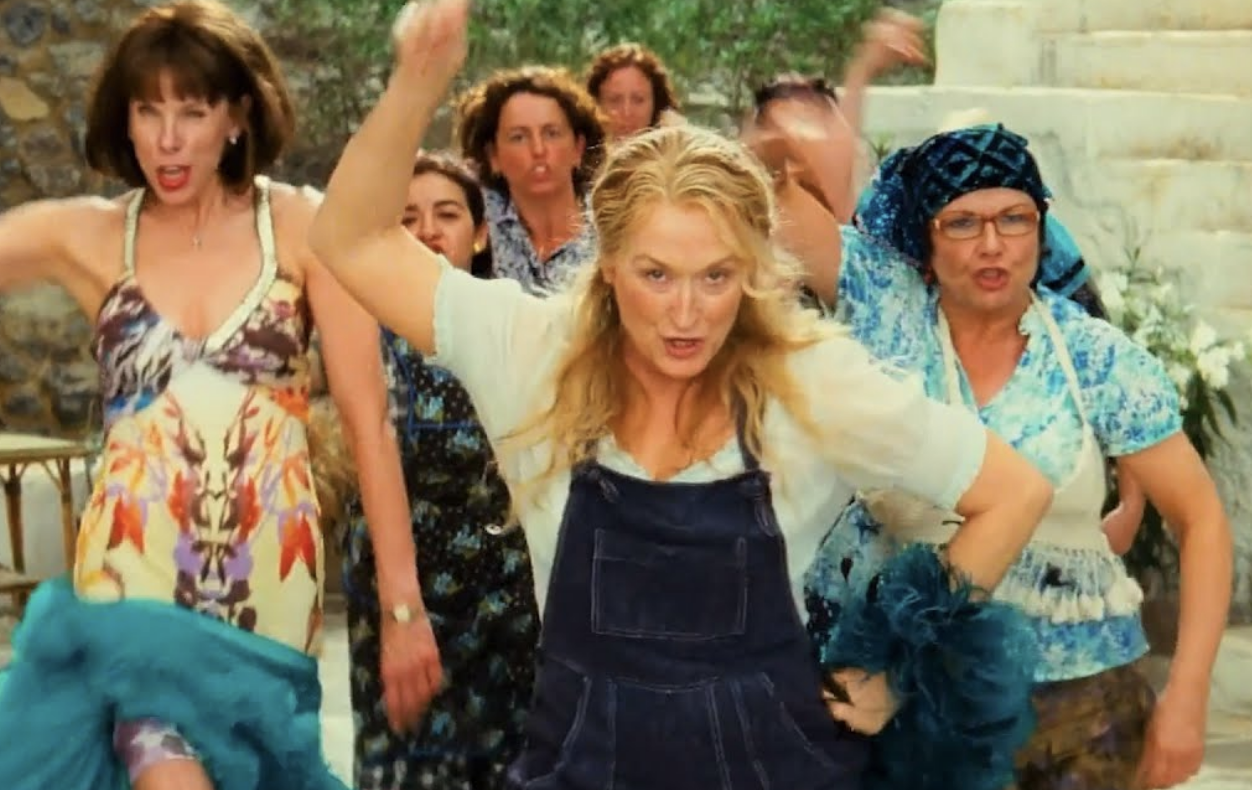 Meryl Streep, Christine Baranski and a group of other women sing and dance through the streets of Greece.