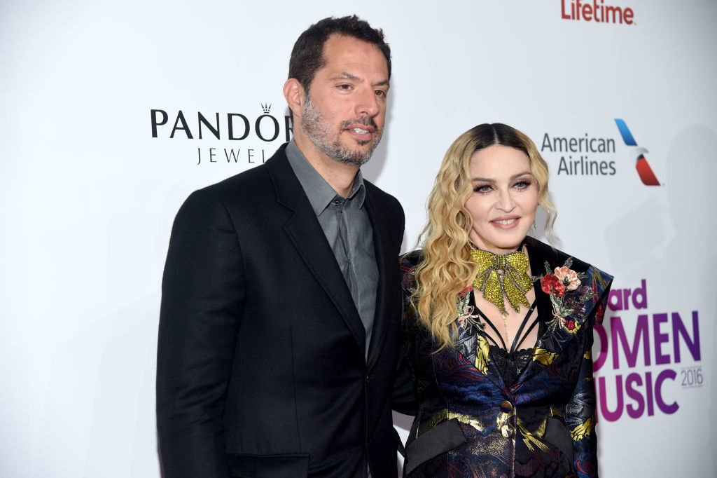 closeup of guy and madonna at an event