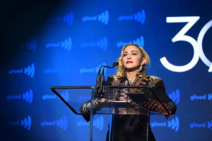 Madonna standing on stage at a podium