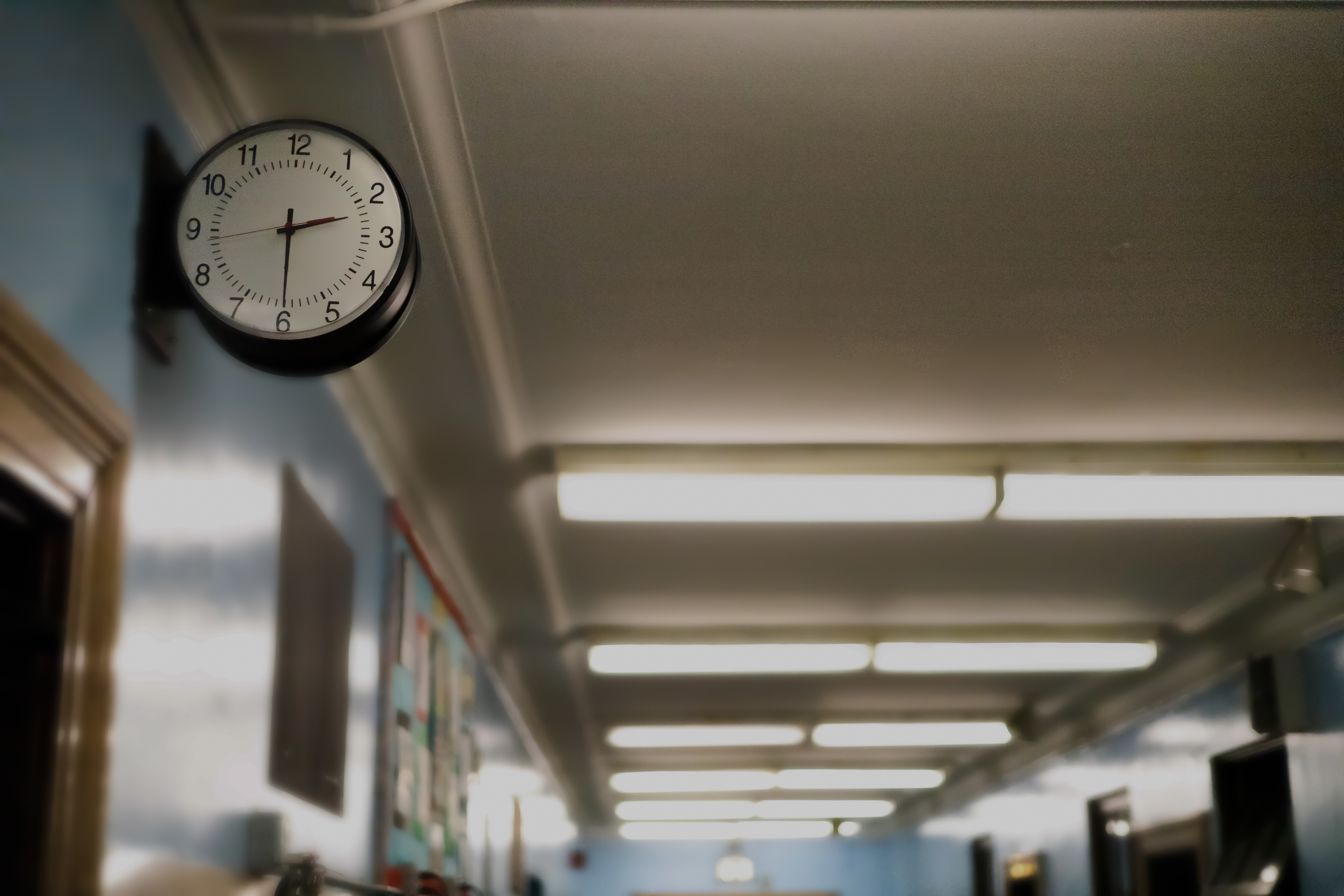 Close-up of a clock in a school hallway
