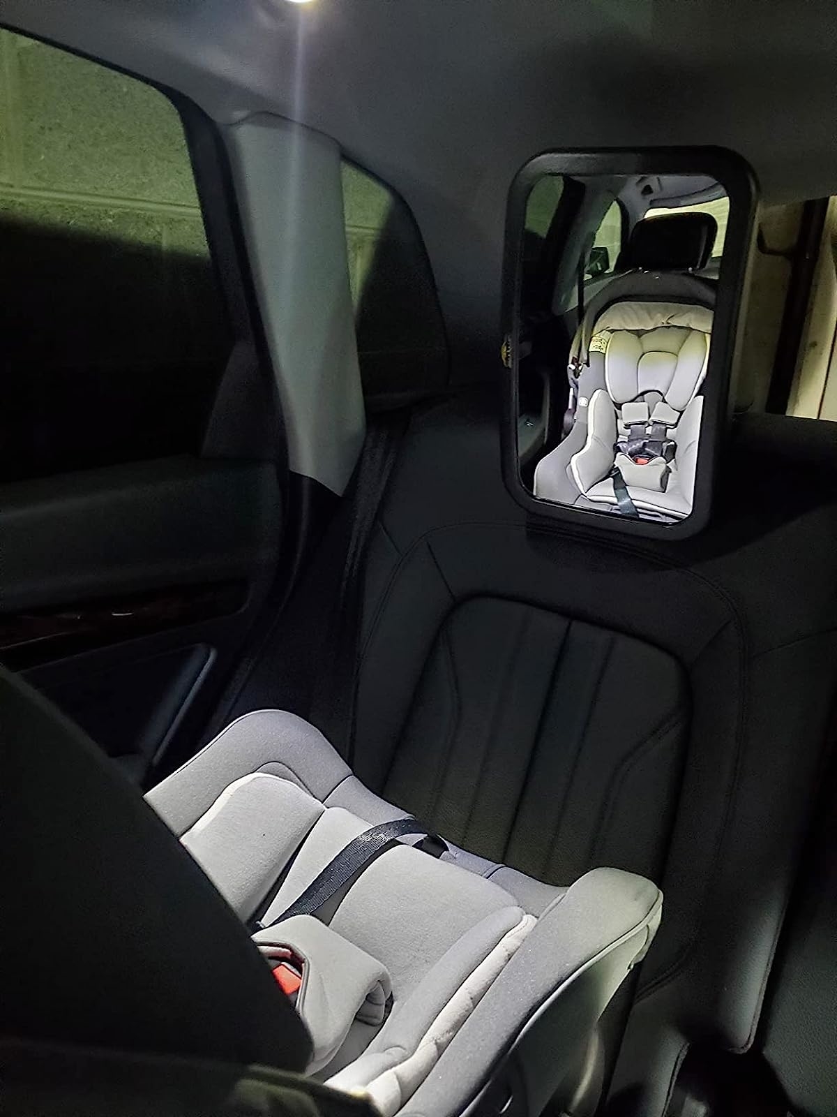 Mirror in car showing car seat