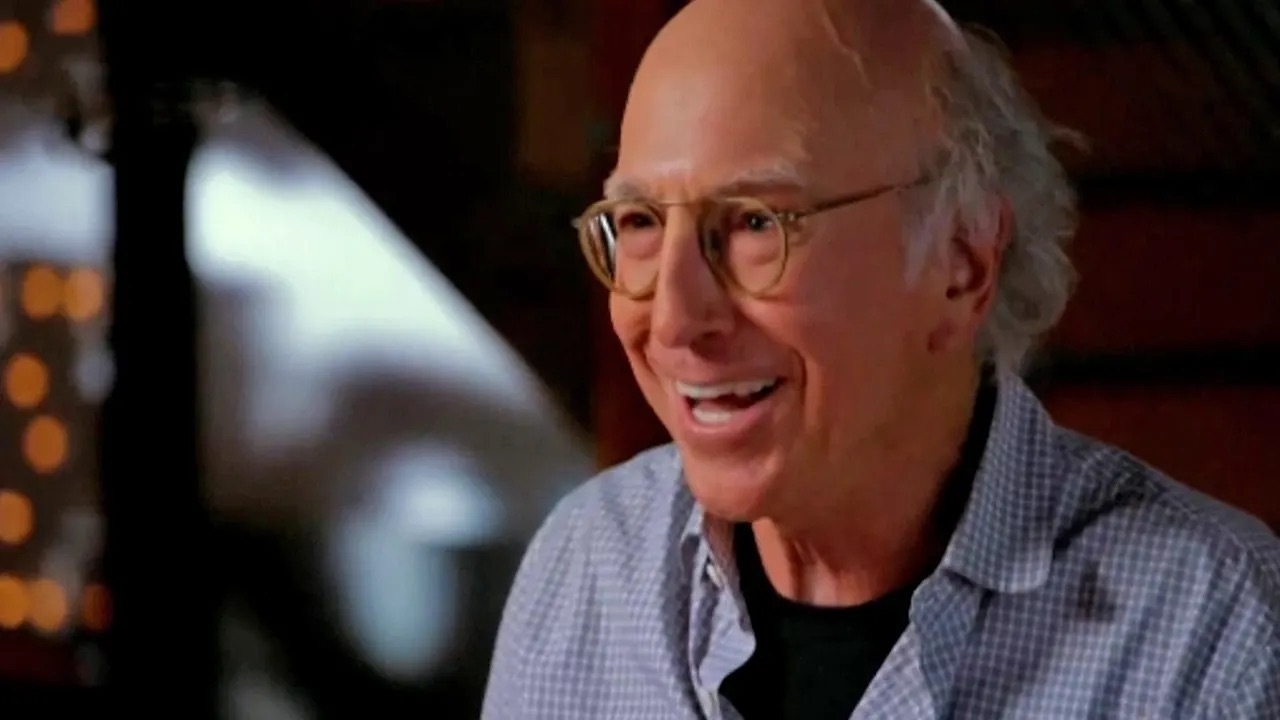 A screenshot of Larry David laughing and looking surprised