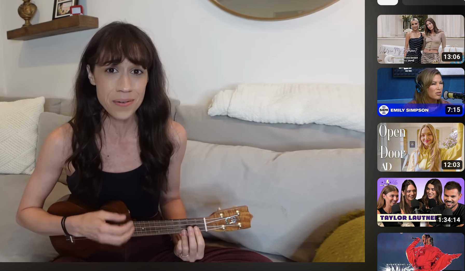 Closeup of Colleen singing and playing the ukulele