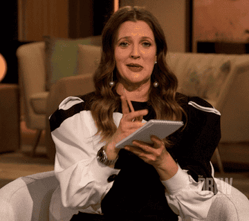 Gif of Drew Barrymore preparing to write on a notepad