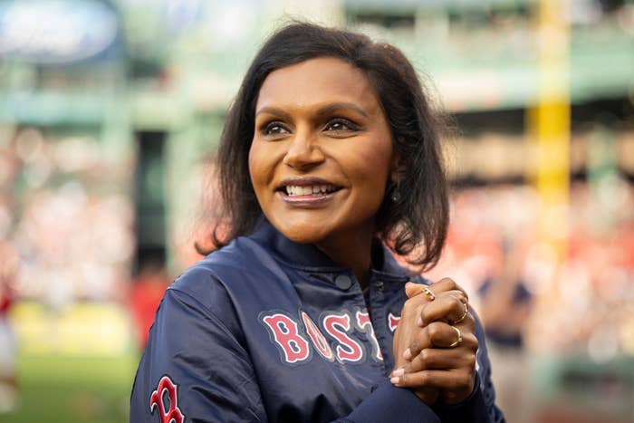 Mindy Kaling flashes a smile at a baseball game