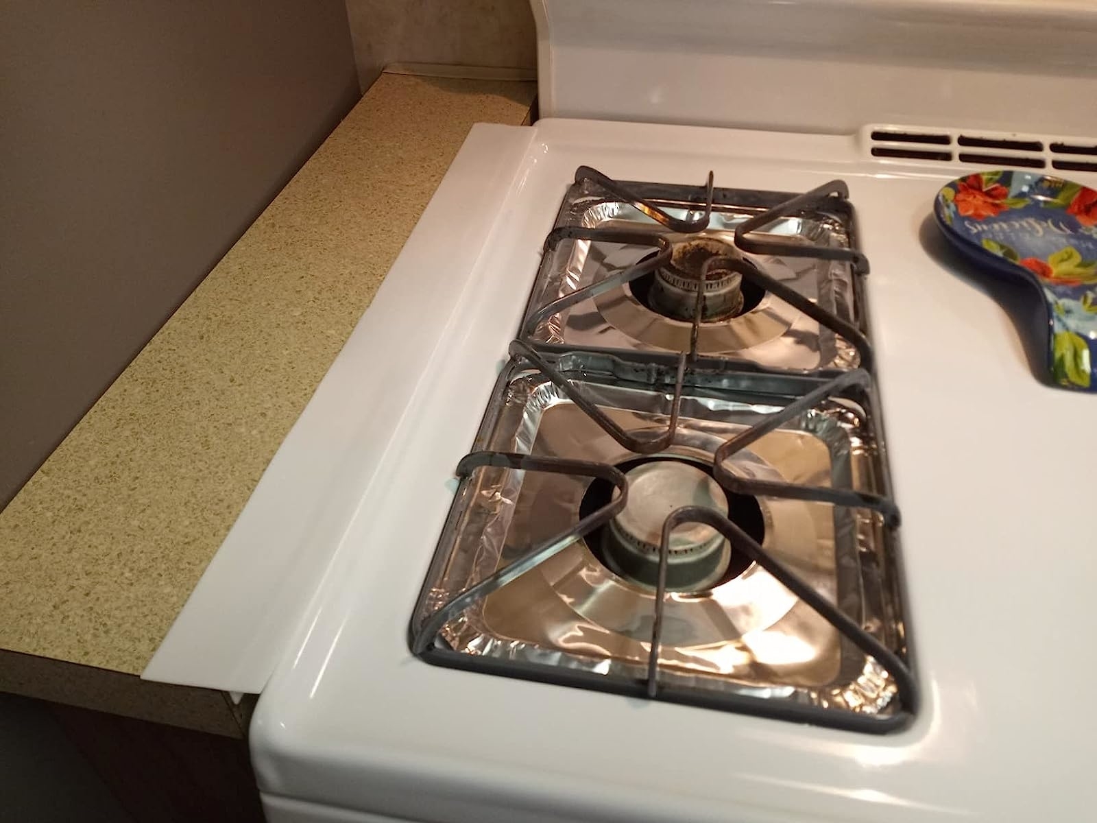 Reviewer&#x27;s white stove with white gap cover sealing gap between counter