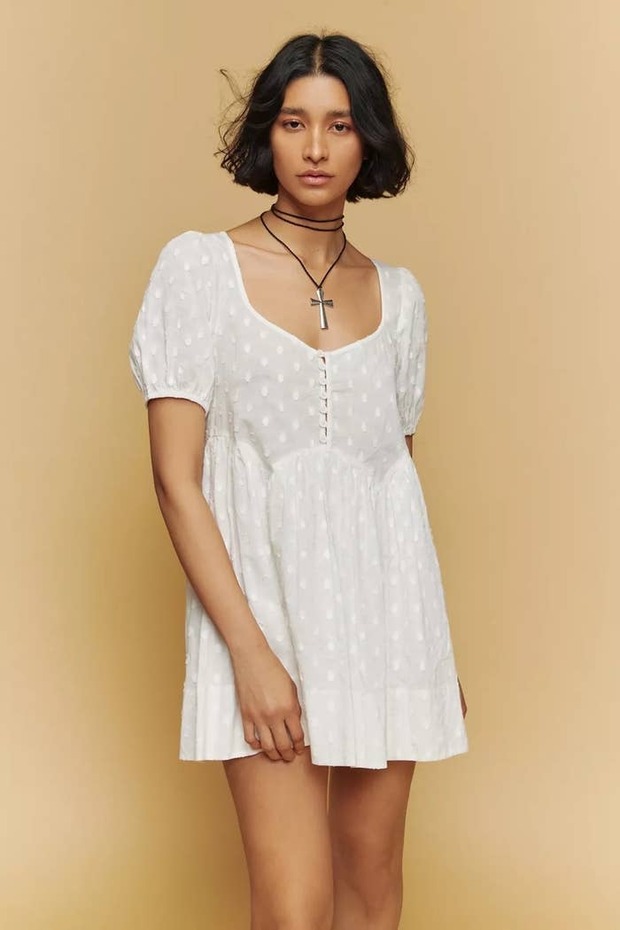 Model wearing white mini dress