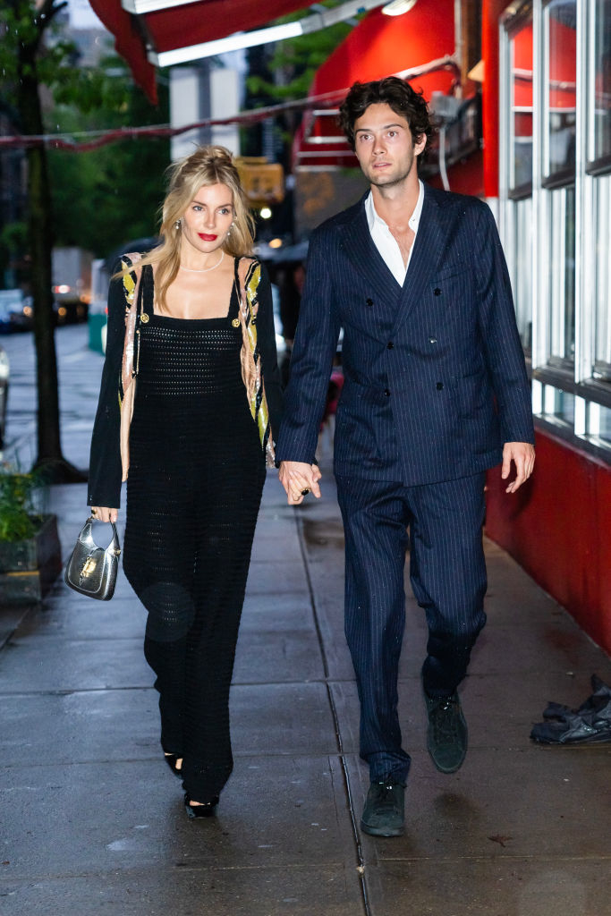 Sienna and Oli walking on the street holding hands