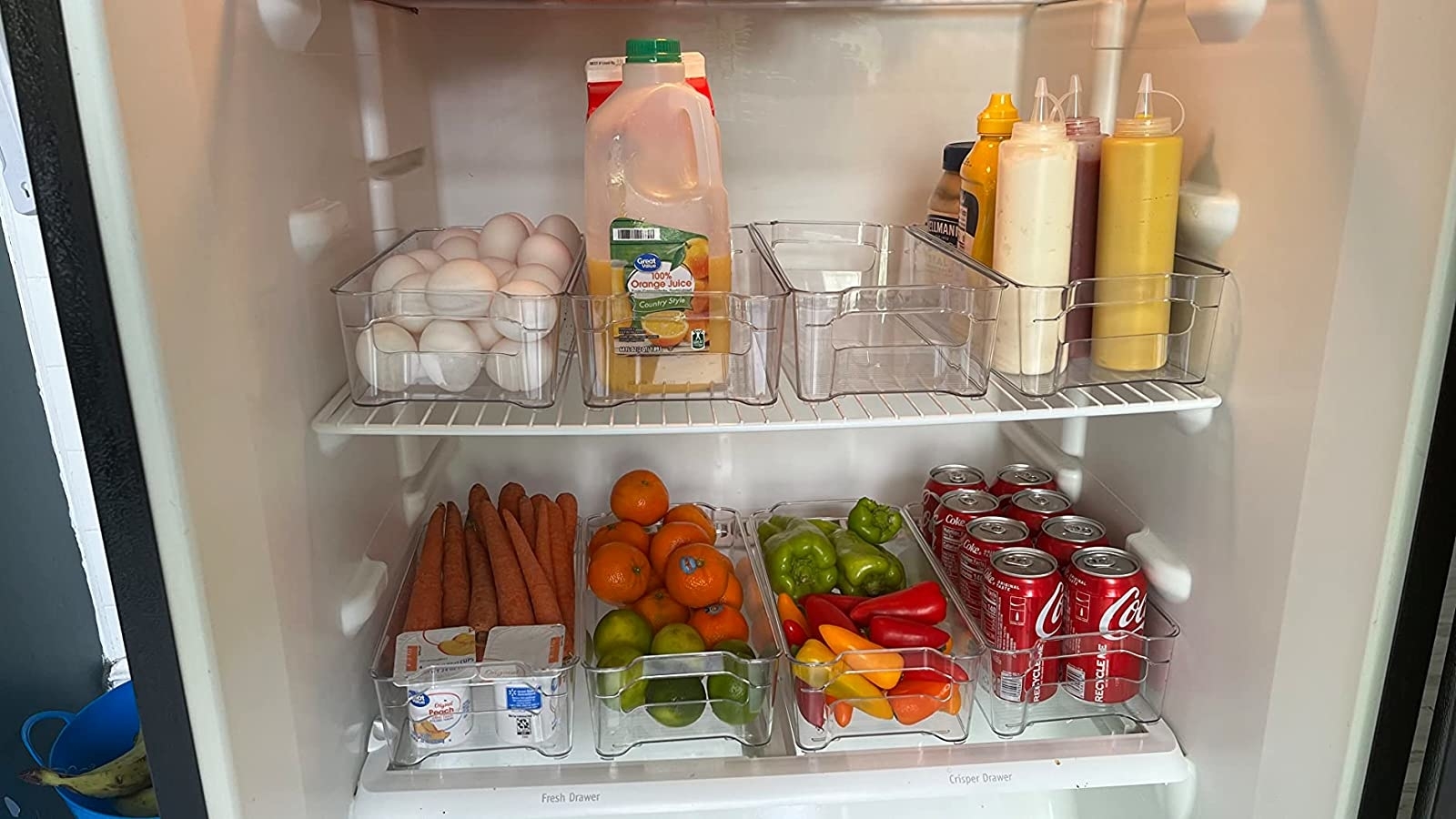 Reviewer&#x27;s fridge with eight bins organizing various items inside