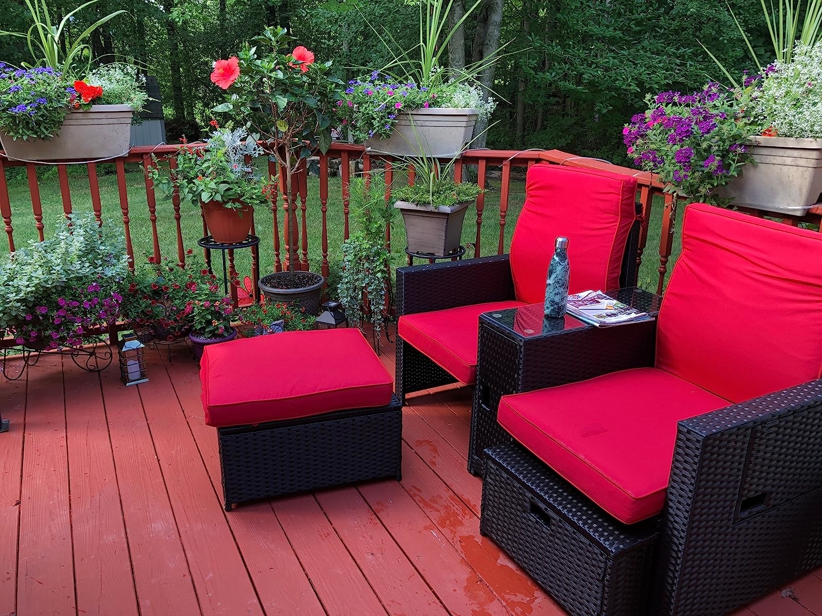 reviewer's high-back chairs with storage ottomans with bright red cushions