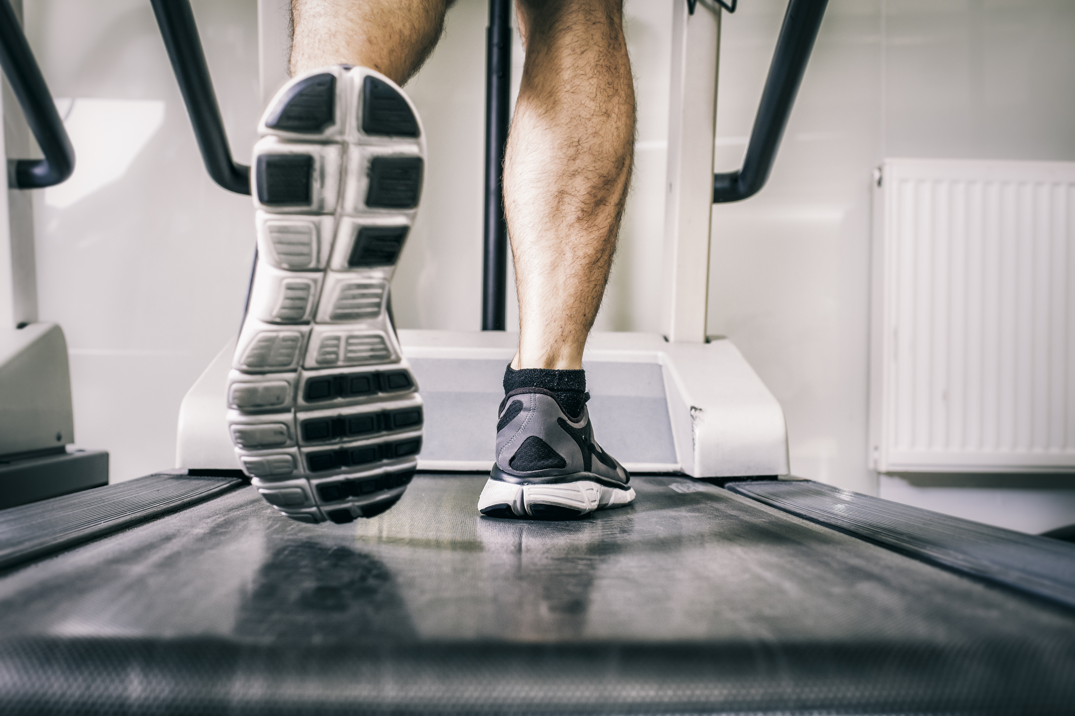 closeup of feet running on a treadmill