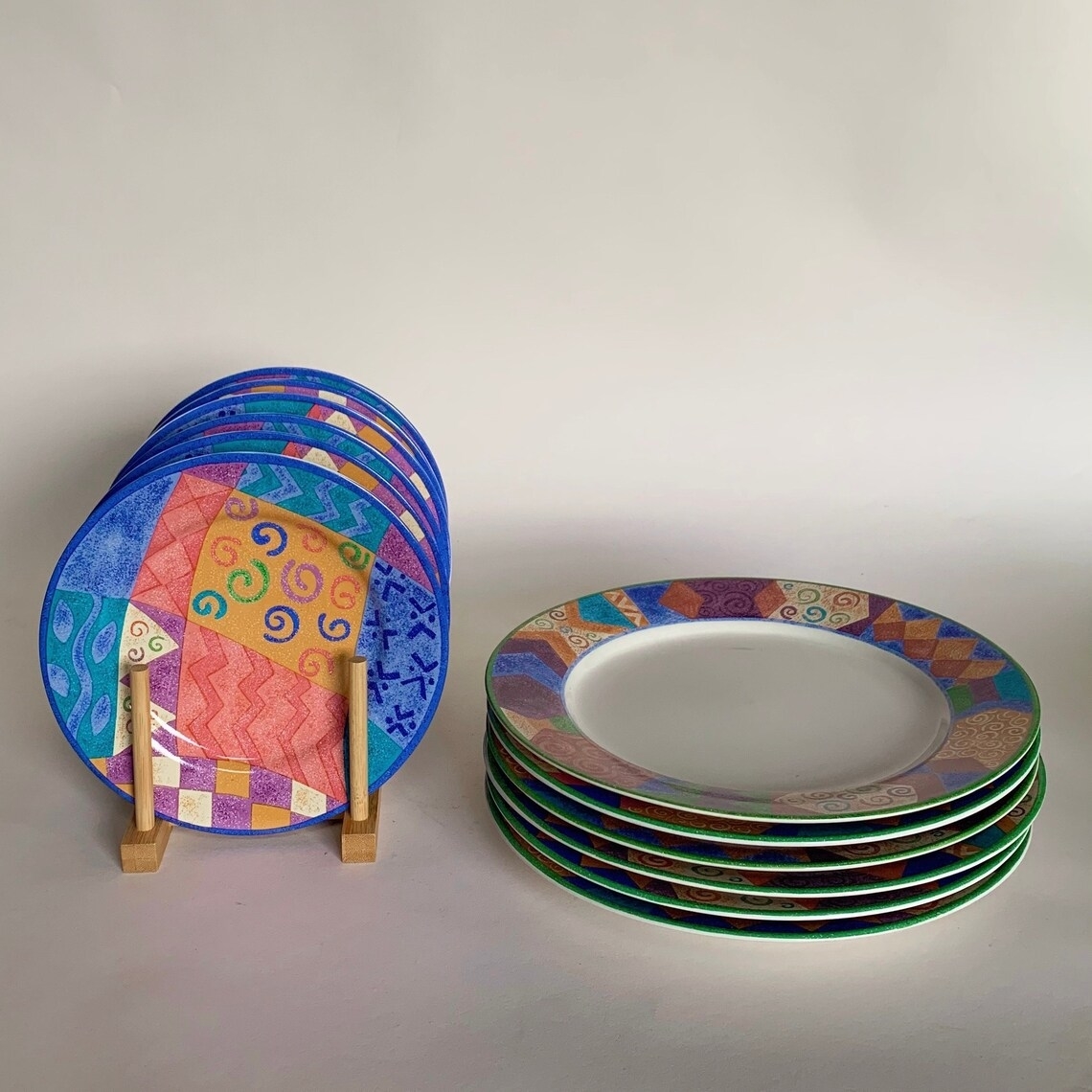 Close-up of a stack of colorful plates and other colorful plates in a rack