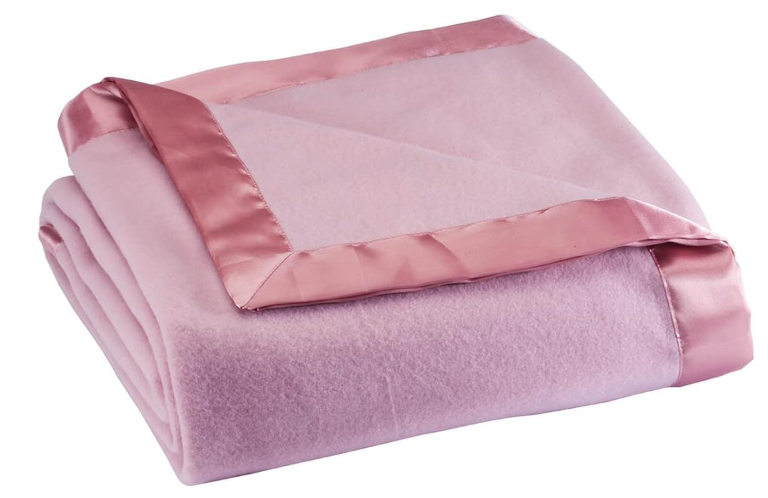 Close-up of a folded fleece blanket with the satin trim