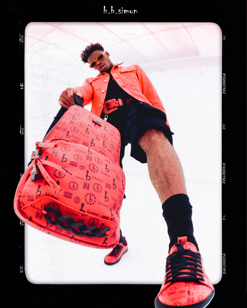 A Model wears red B.B. Simon pieces and presents a new backpack designed by the bnrand.