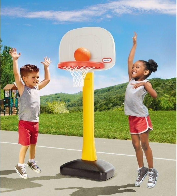 Kids play with a basketball hoop