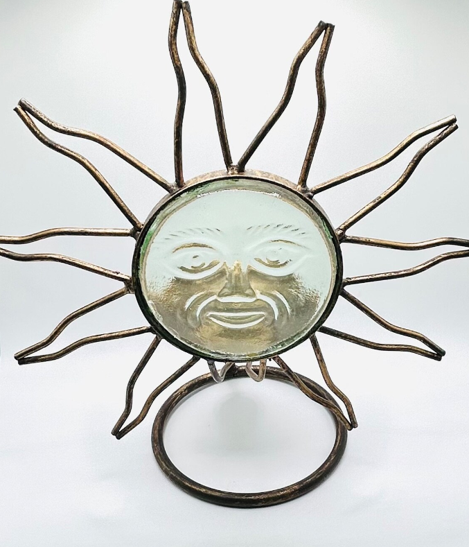 Close-up of a starburst sun-face metallic creation