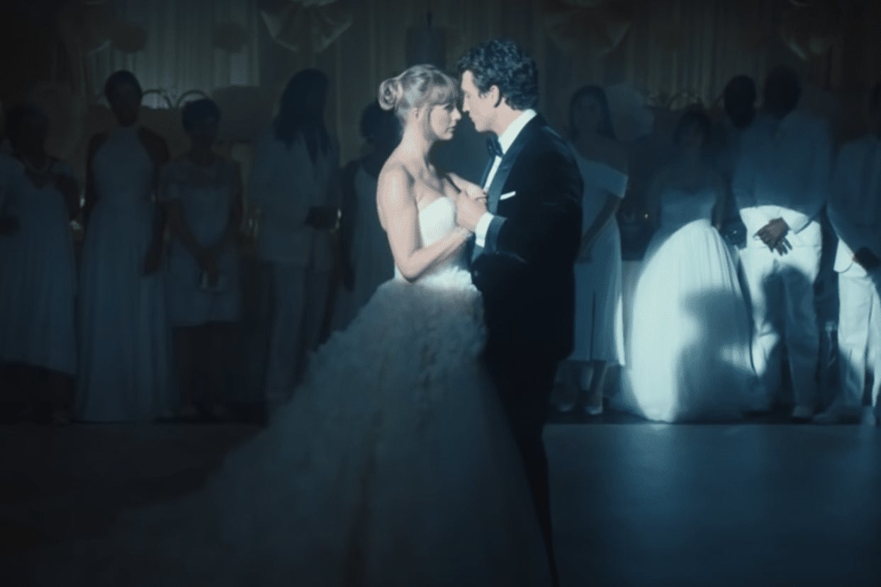 Taylor Swift and Miles Teller dancing together on their wedding day in the I Bet You Think About Me music video