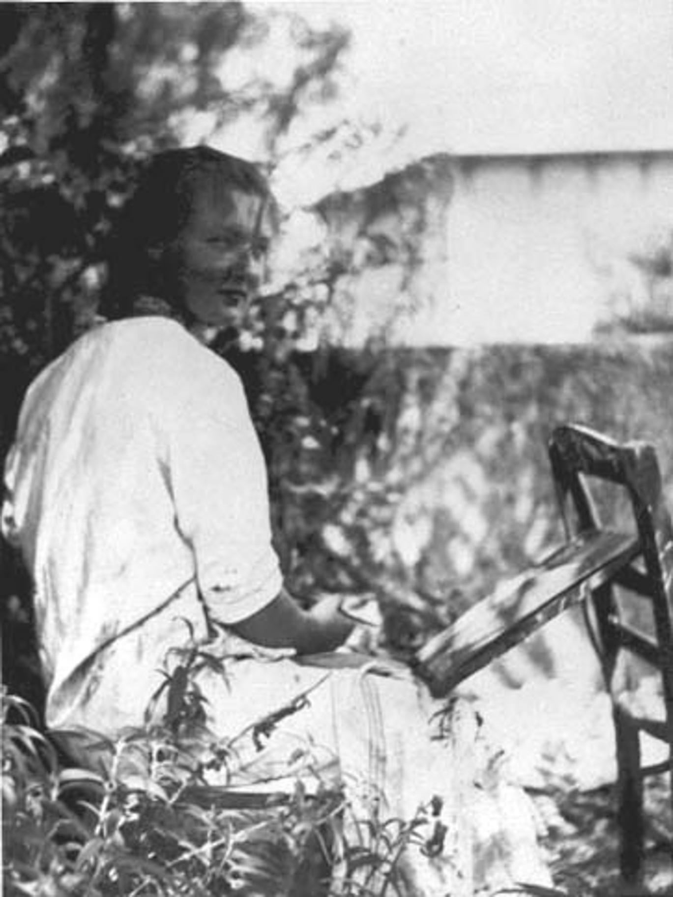 Photo of Charlotte Salomon, painting in a garden.