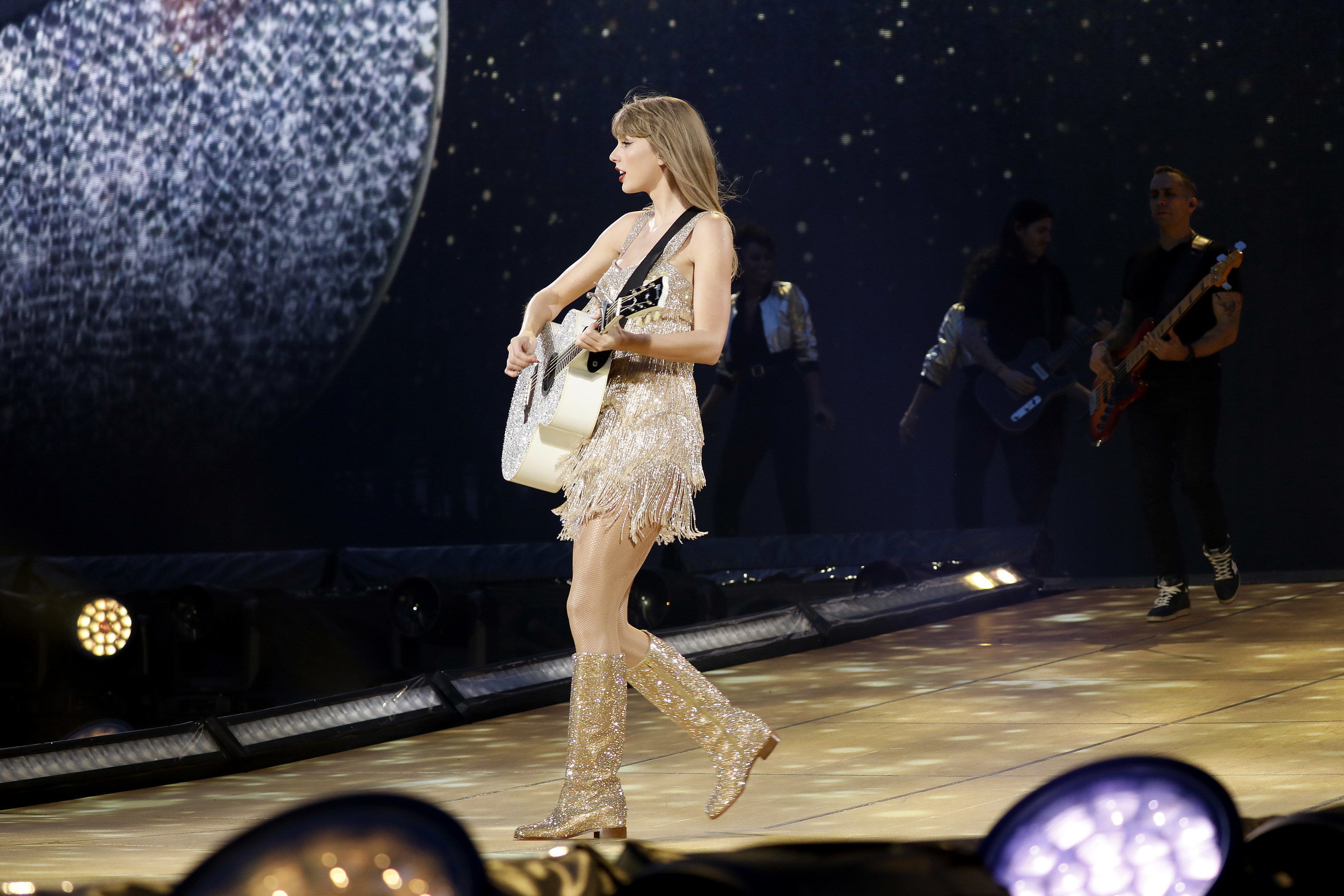 taylor playing guitar on stage