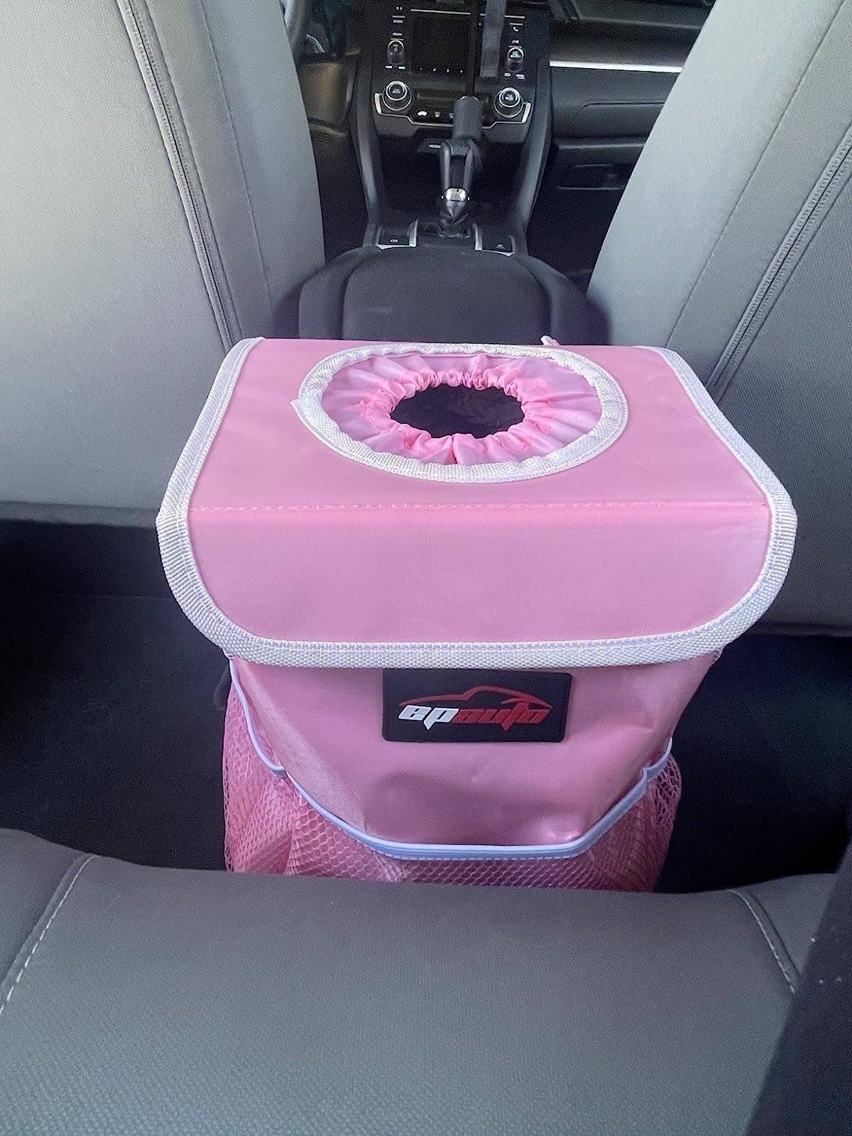 Reviewer's representation  of pinkish  car   trash tin  successful  mediate  of backseat
