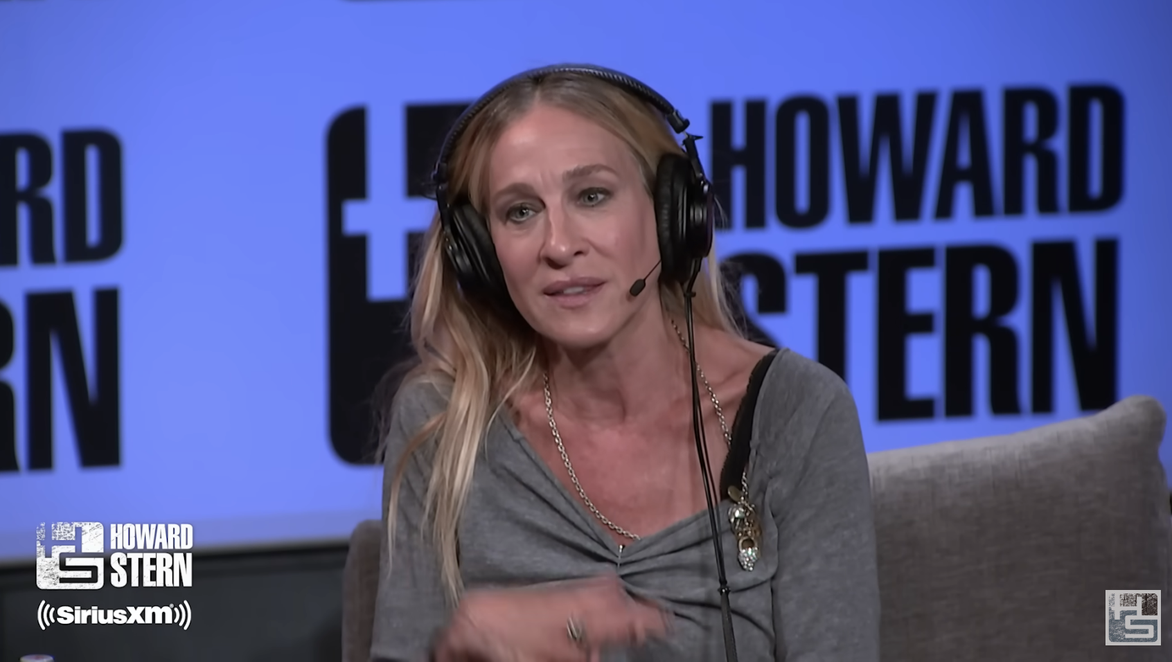 Close-up of SJP on the Howard Stern set, wearing headphones