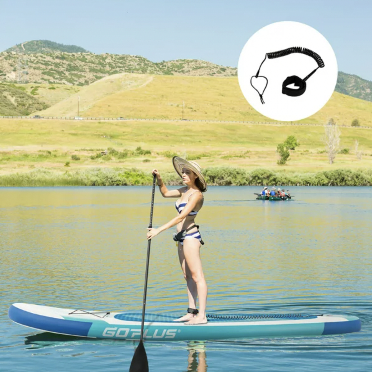 Model paddling on paddleboard while standing on lake which bungee strap connected to ankle