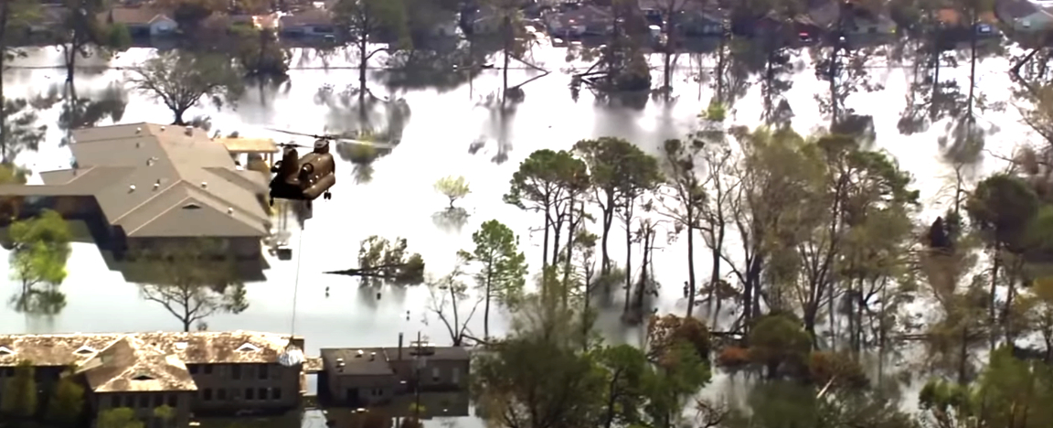 A chopper delivers a package to a flooded town