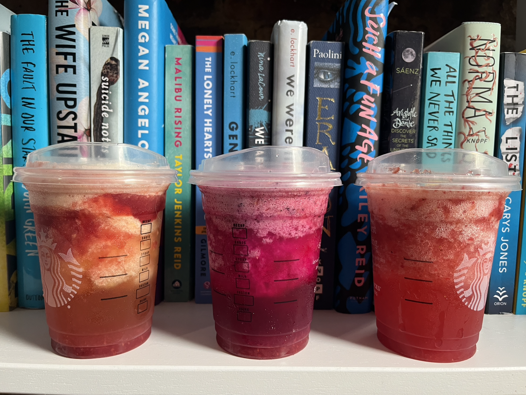 the 3 drinks in front of books