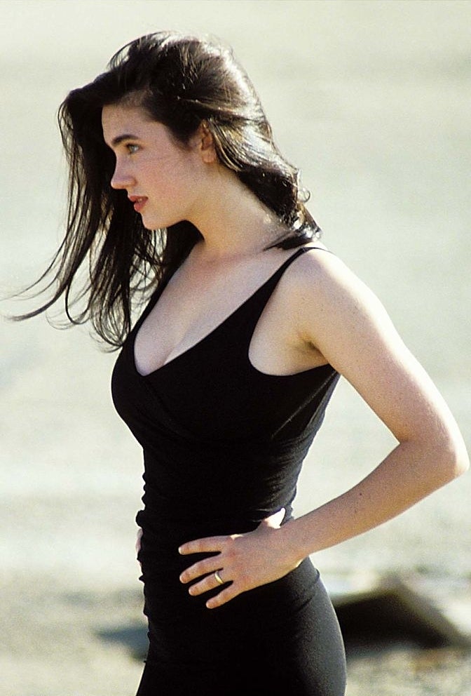 Side view of her in a sleeveless V-neck top