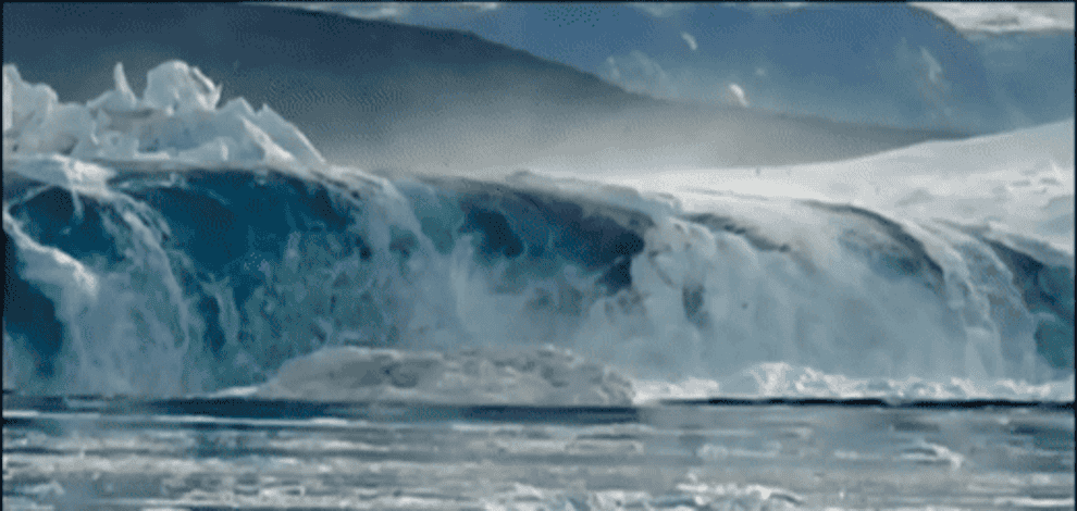 A wave lifts an iceberg