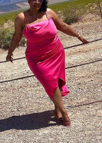 reviewer wearing pink slip midi dress with heels