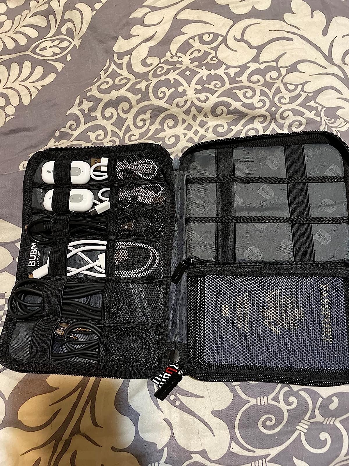 Reviewer&#x27;s gadget bag with cords and passport tucked in sleeves