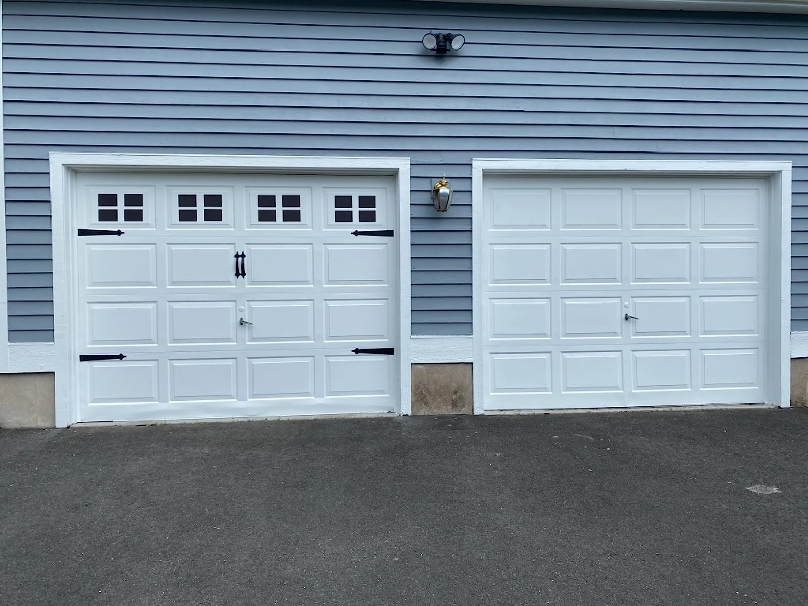 a reviewer photo of side by side garage doors, one with the magnets applied and one without