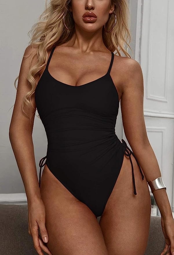 model posing in black one piece swimsuit