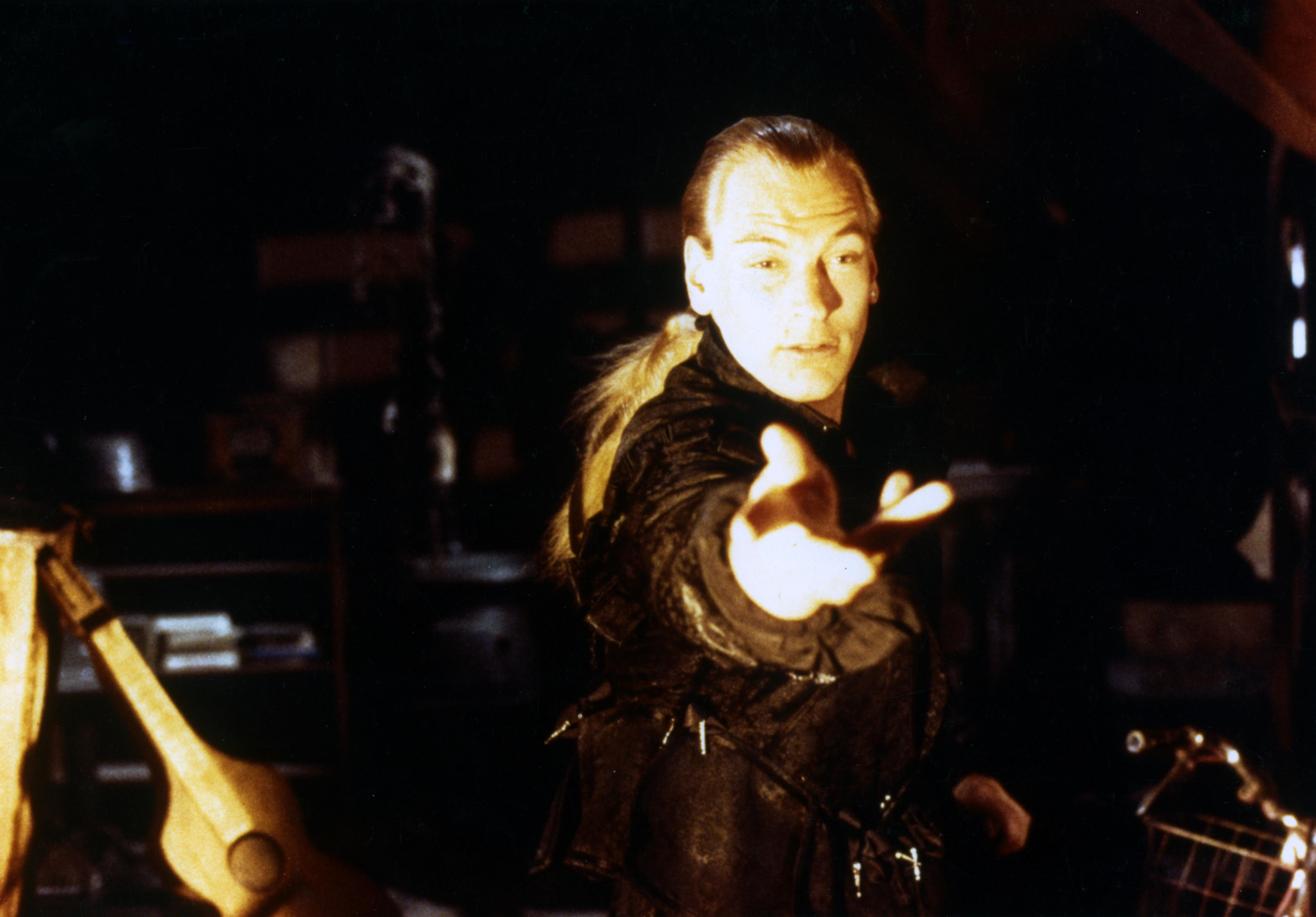 Julian Sands attempts to conjure witchcraft in a dark room