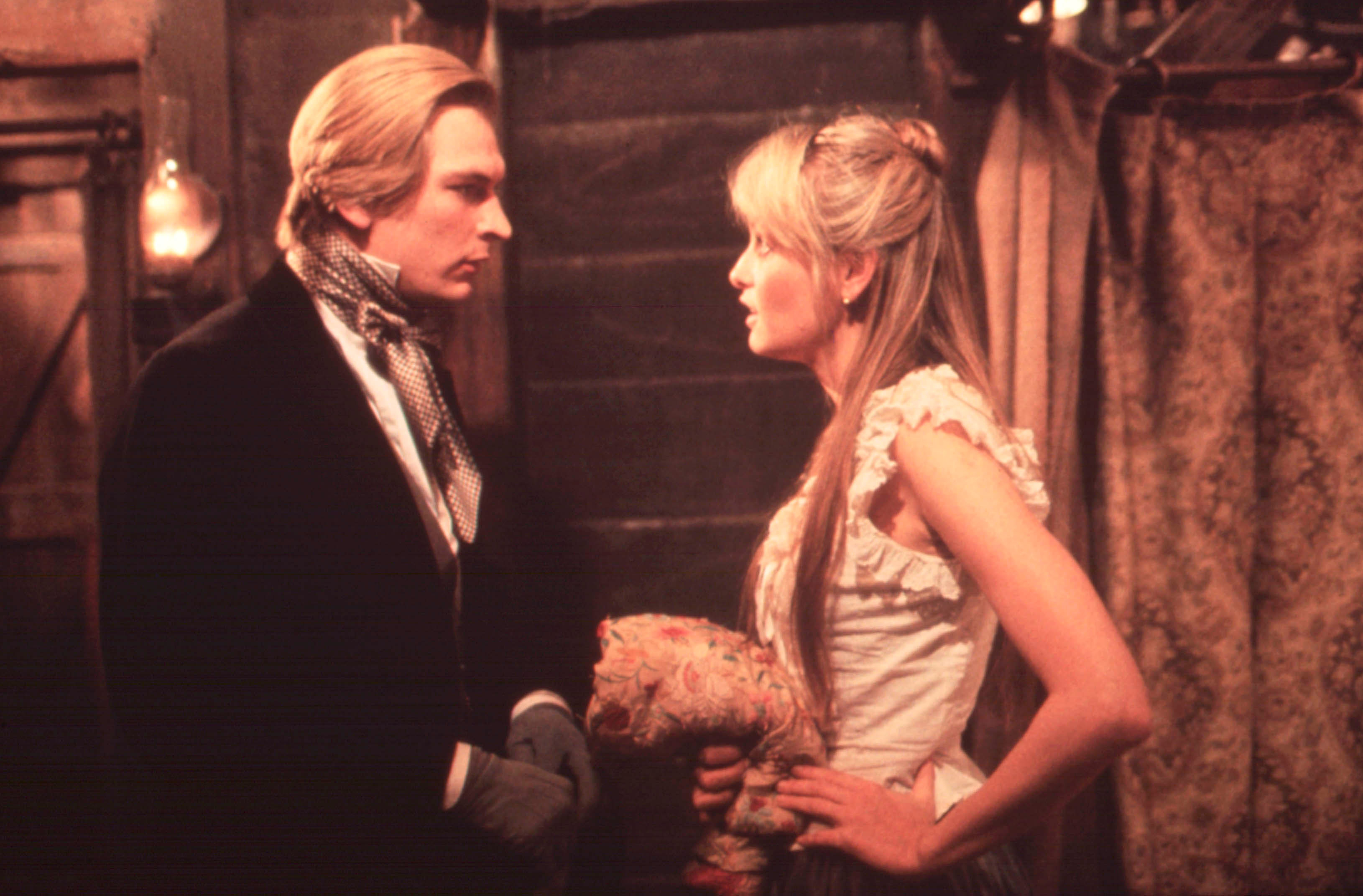 Julian Sands speaks to Twiggy Lawson in a late 1800s English home