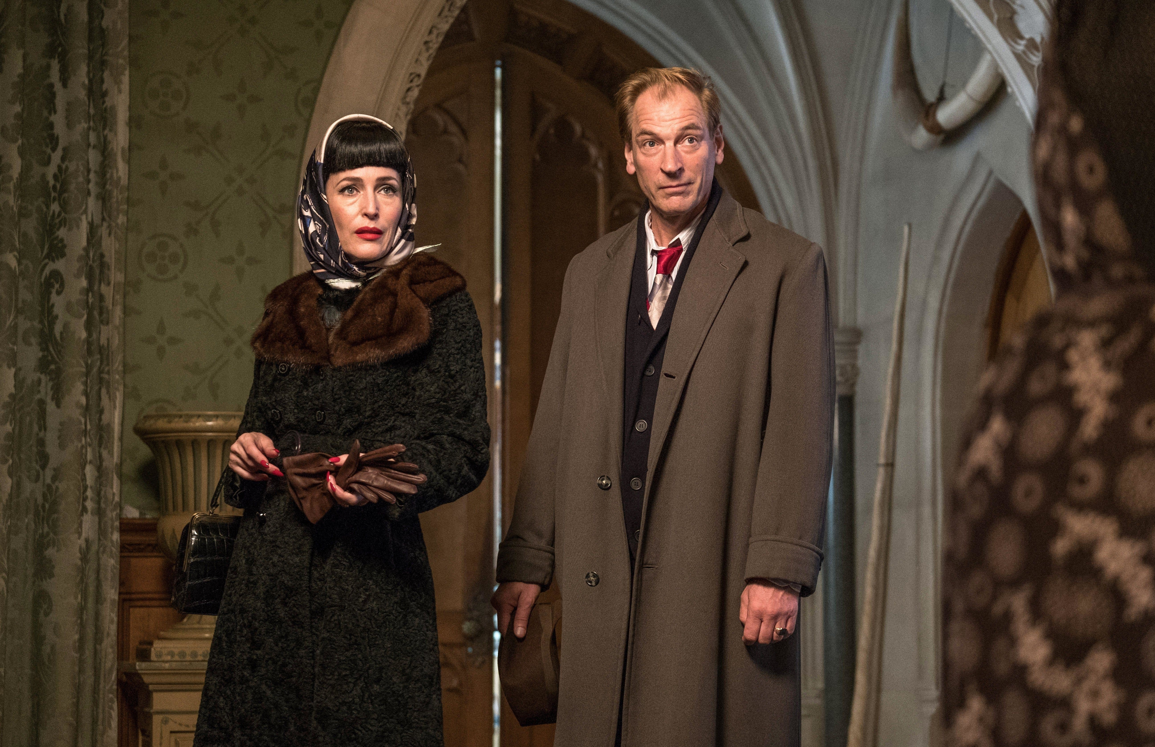 Julian Sands and Gillian Anderson adorn expensive coats in a notable estate