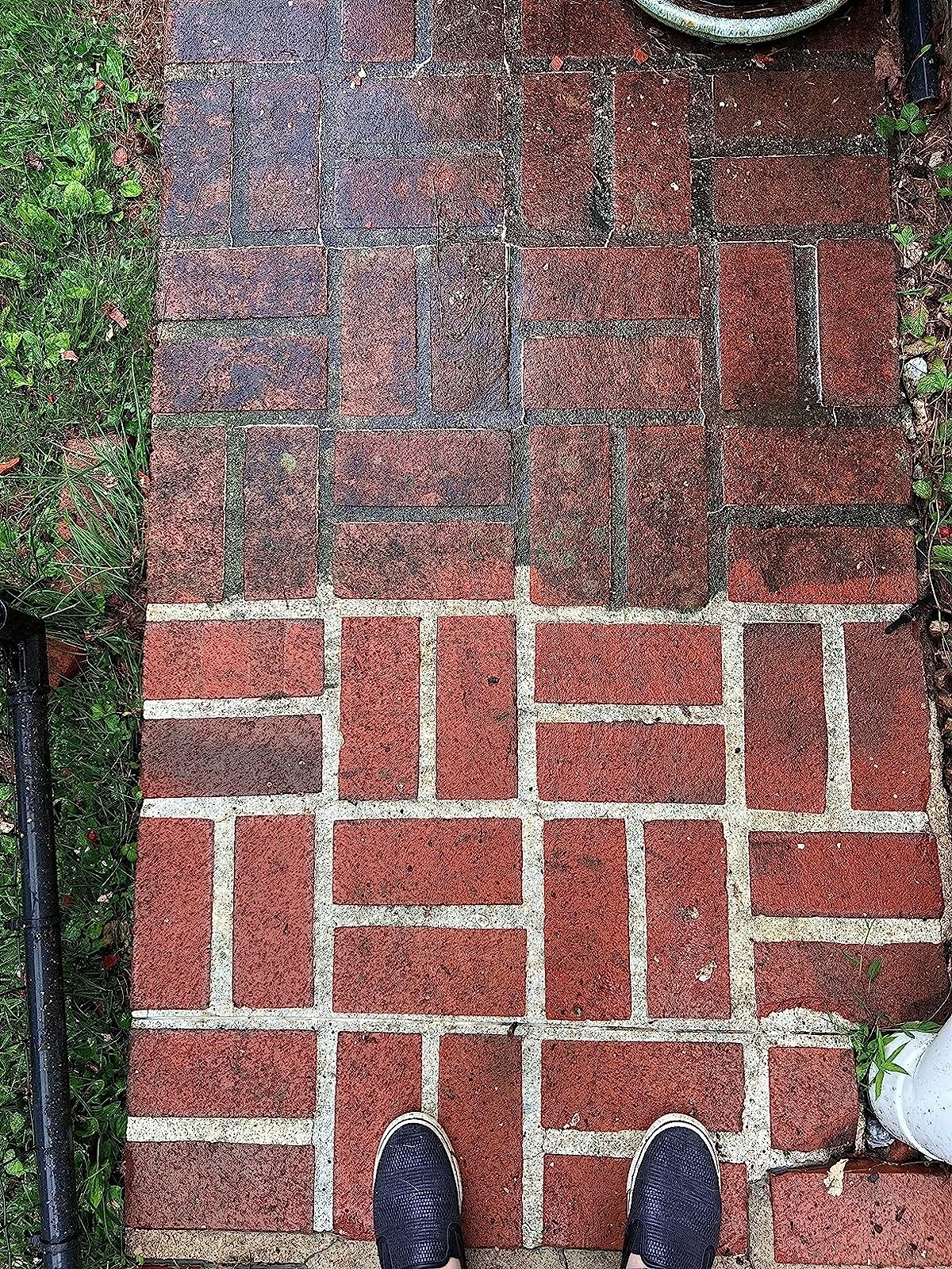 a reviewer photo of a brick walkway, half pressure washed and half not