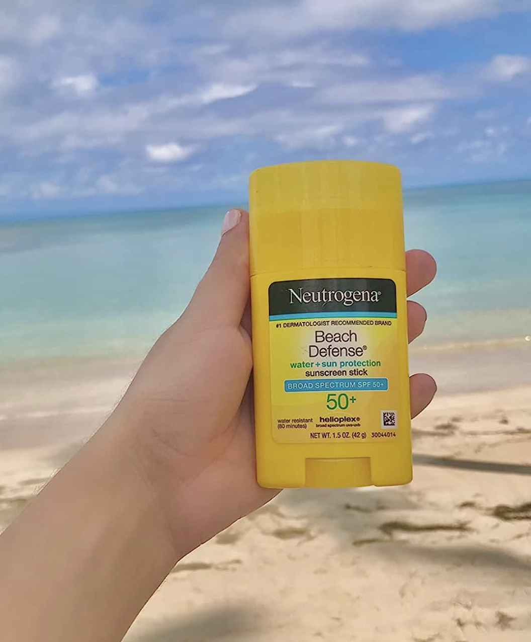 a reviewer with the sunscreen on the beach