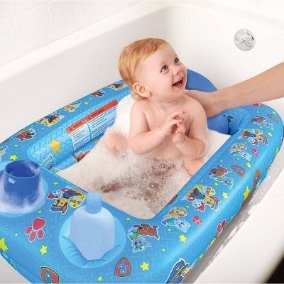 Baby model sits in an inflatable bathtub