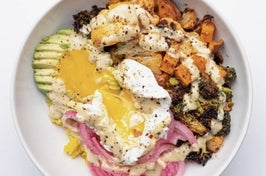 bowl of sweet potatos broccoli pickled onions and avocado topped with an egg and dressing