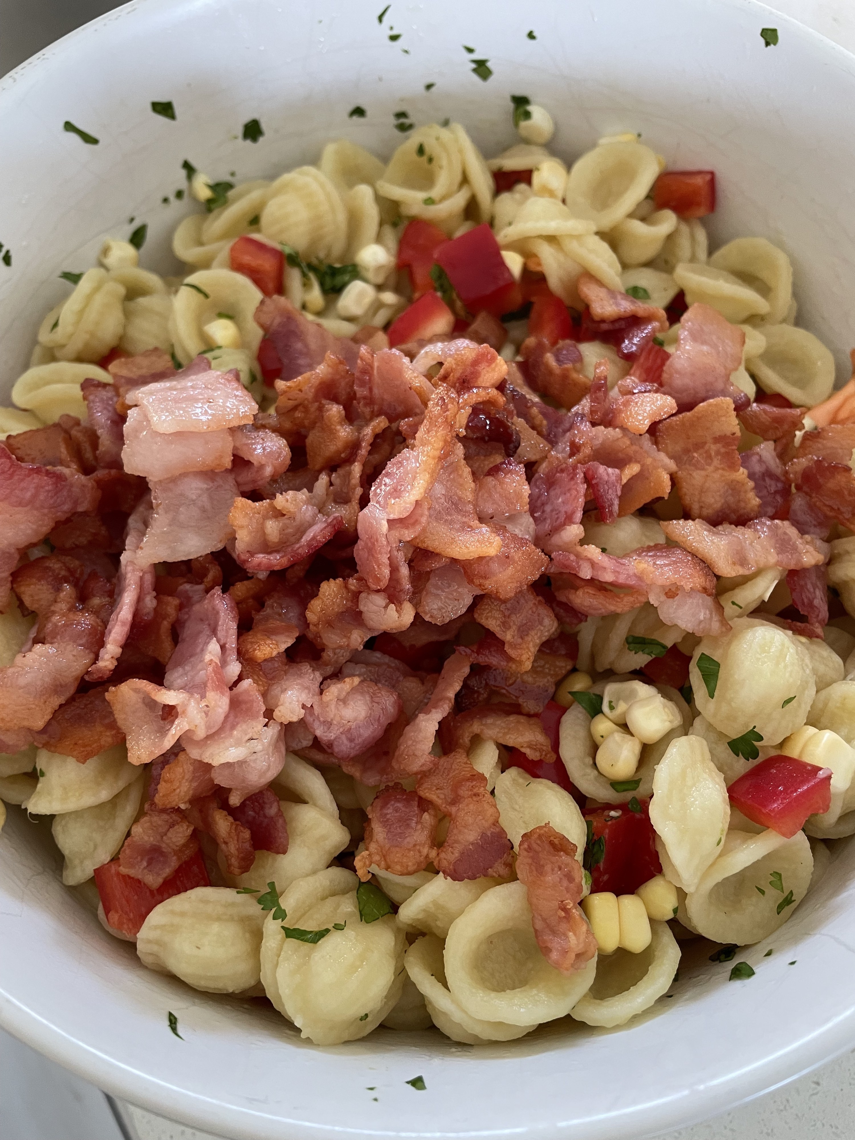 Bacon and corn pasta salad in a bowl