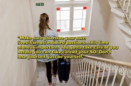 A woman carries her luggage down stairs