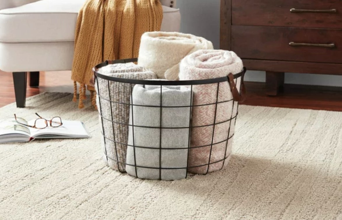 the wire basket with towels in it