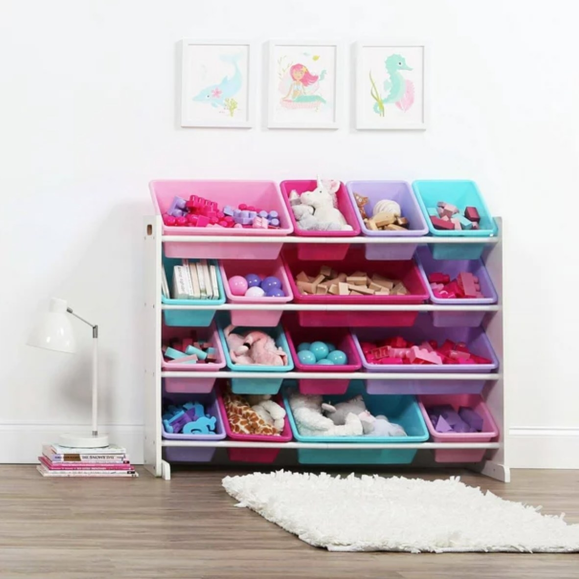 a toy organizer with multicolored bins filled with toys in a kid&#x27;s room