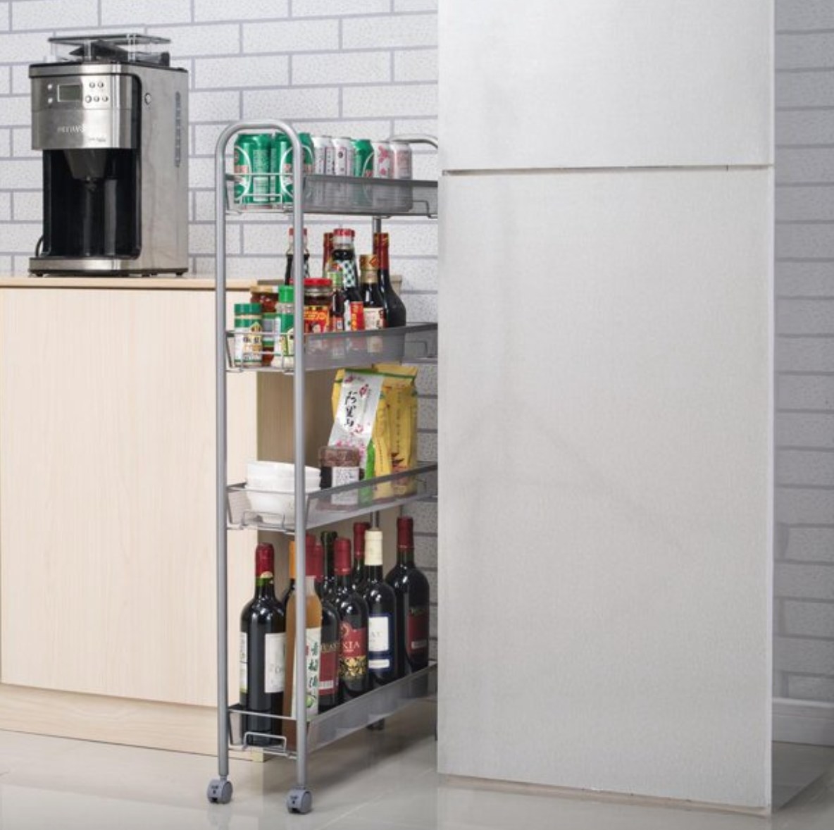a rolling cart with bar supplies and condiments in between a counter and a refrigerator