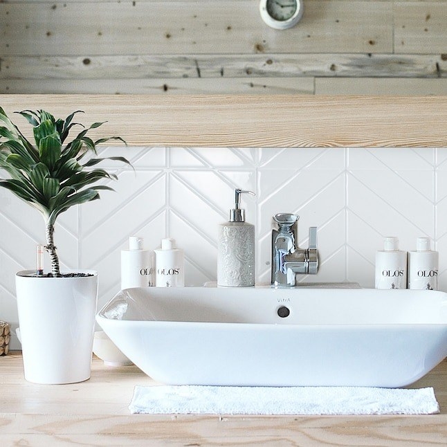 the white chevron tiles in a bathroom as a backsplash